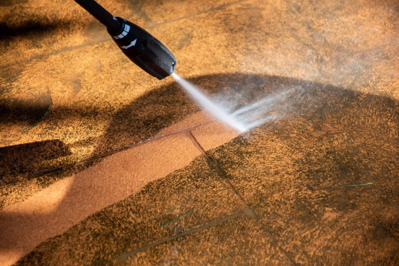 Pressure washing a paved driveway at an Adelaide property